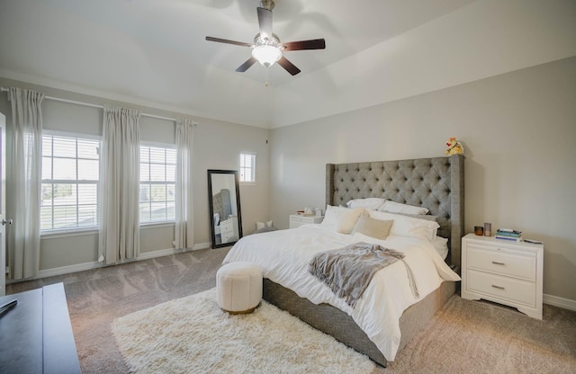 bedroom featuring carpet flooring, vaulted ceiling, and ceiling fan