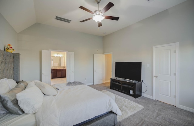 bedroom with ceiling fan, ensuite bathroom, high vaulted ceiling, and light carpet