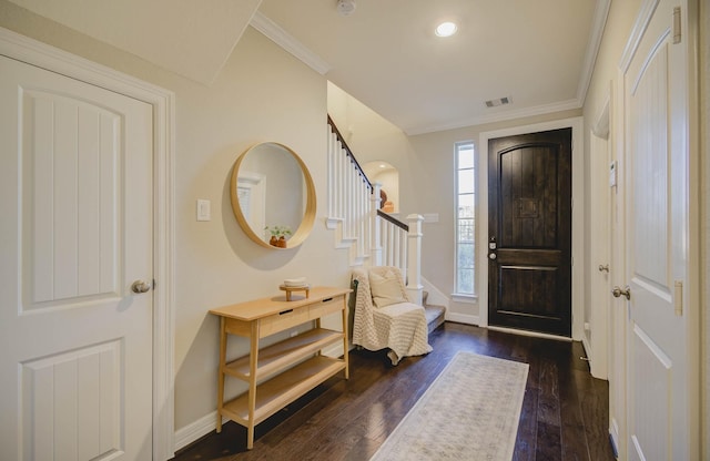 entryway featuring dark wood-type flooring and ornamental molding