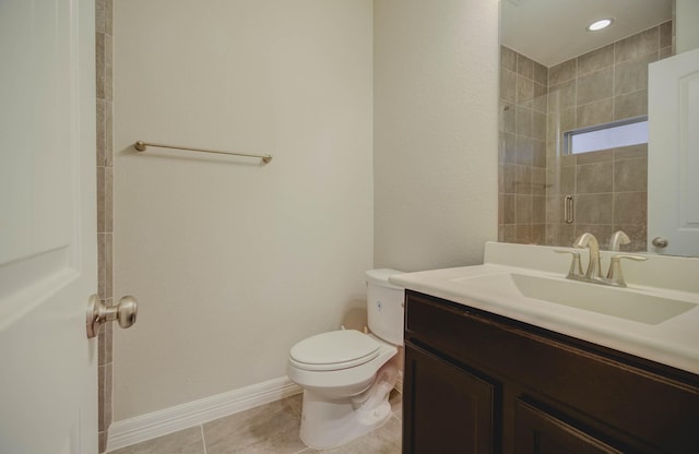 bathroom featuring a shower, tile patterned floors, vanity, and toilet