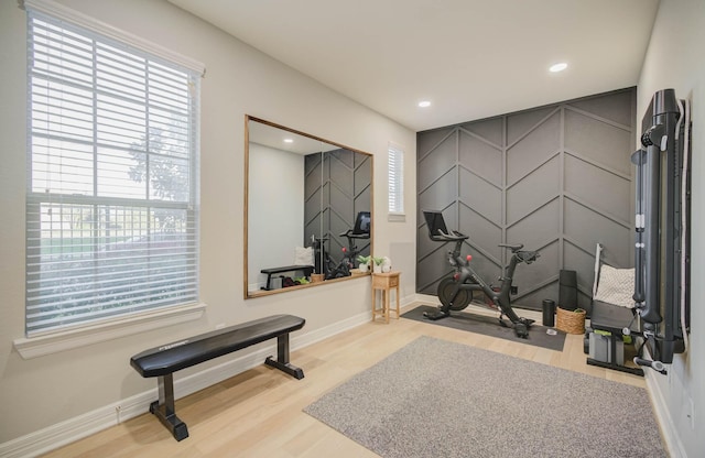 exercise room featuring light wood-type flooring