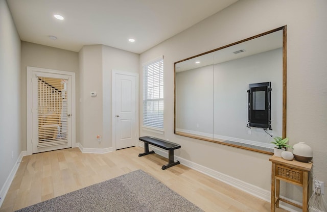 exercise room featuring light hardwood / wood-style floors