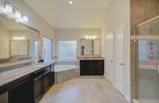 bathroom featuring tile patterned floors, vanity, independent shower and bath, and lofted ceiling