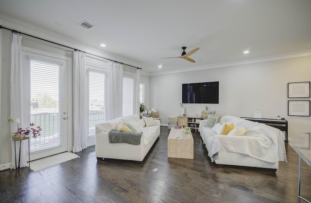 living room with a healthy amount of sunlight, dark wood-type flooring, and crown molding