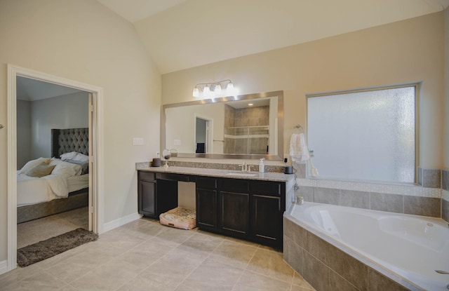 bathroom with tile patterned flooring, vanity, independent shower and bath, and lofted ceiling