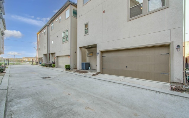 exterior space featuring cooling unit and a garage