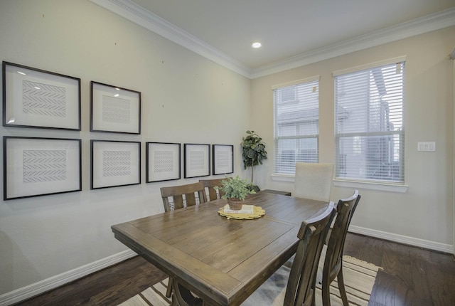 dining space with hardwood / wood-style flooring and crown molding