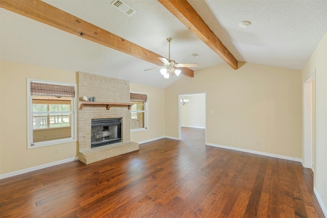 unfurnished living room featuring lofted ceiling with beams, ceiling fan with notable chandelier, a textured ceiling, a fireplace, and dark hardwood / wood-style flooring