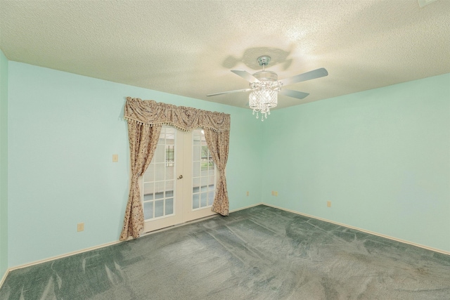 carpeted spare room featuring french doors, a textured ceiling, and ceiling fan