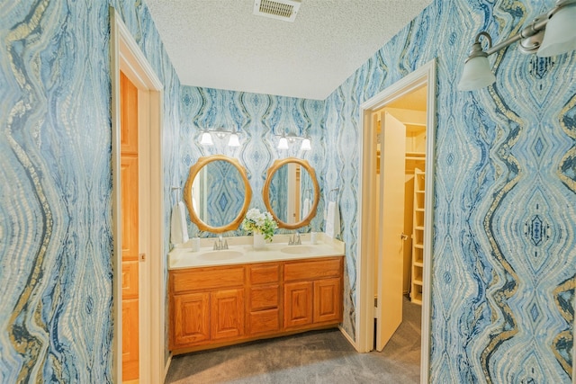 bathroom with vanity and a textured ceiling