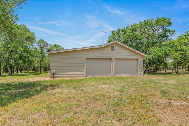 garage featuring a lawn