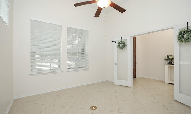 tiled spare room featuring ceiling fan