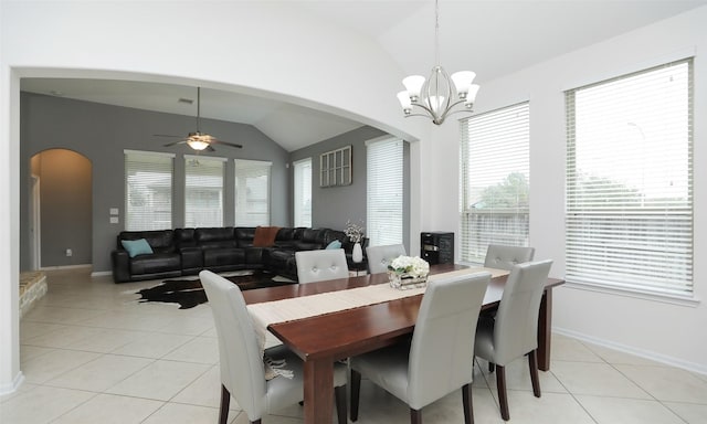 dining room featuring lofted ceiling, light tile patterned floors, ceiling fan with notable chandelier, and plenty of natural light