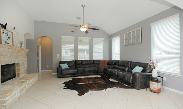 living room featuring lofted ceiling, ceiling fan, light tile patterned floors, and plenty of natural light