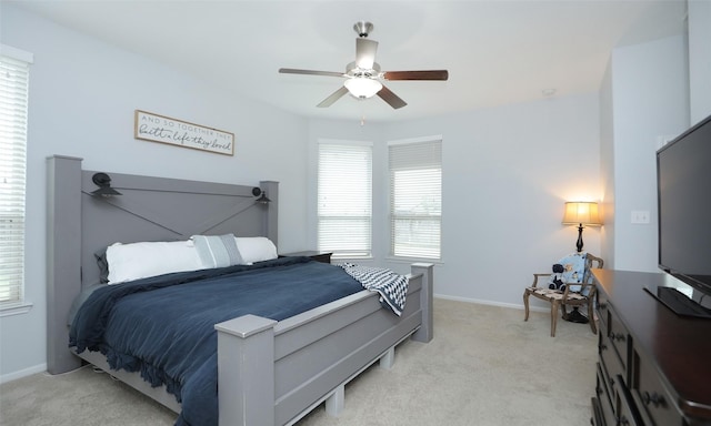 bedroom with ceiling fan and light carpet