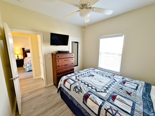 bedroom with ceiling fan and light hardwood / wood-style floors