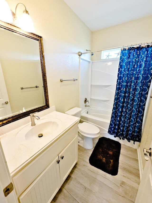 full bathroom with hardwood / wood-style floors, vanity, shower / bath combination with curtain, and toilet