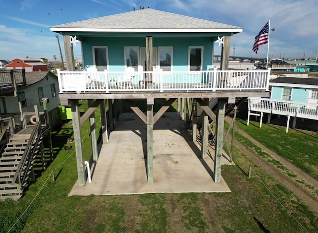 rear view of property featuring a yard and a carport