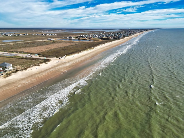 drone / aerial view with a beach view and a water view