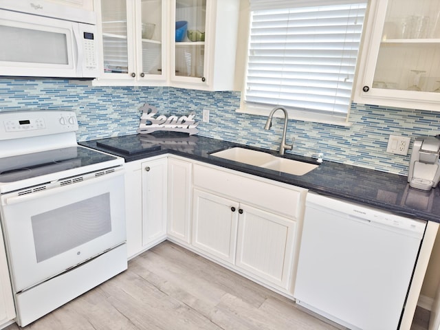 kitchen featuring white cabinetry, sink, white appliances, decorative backsplash, and light wood-type flooring