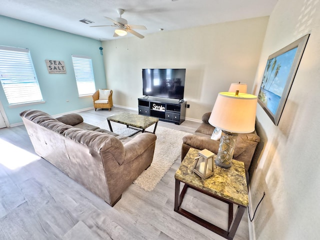 living room with ceiling fan and light wood-type flooring