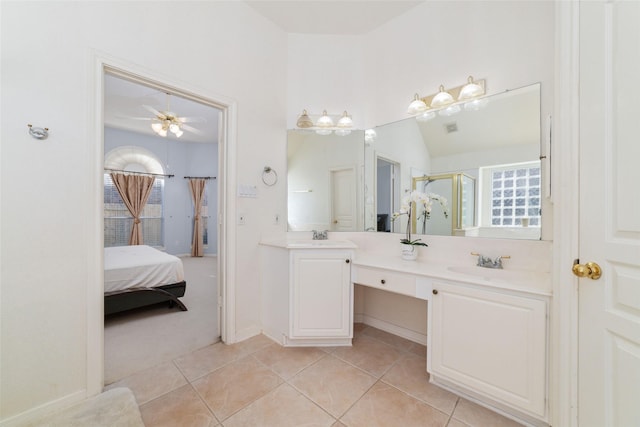 bathroom featuring lofted ceiling, tile patterned flooring, ceiling fan, a shower with door, and vanity