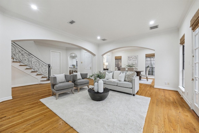 living room featuring light hardwood / wood-style floors and ornamental molding