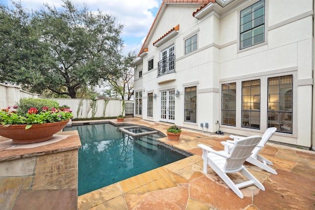 view of swimming pool featuring a patio area and an in ground hot tub