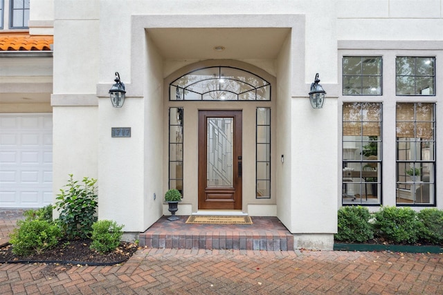 doorway to property with a garage