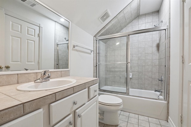 full bathroom featuring tile patterned flooring, enclosed tub / shower combo, vaulted ceiling, toilet, and vanity