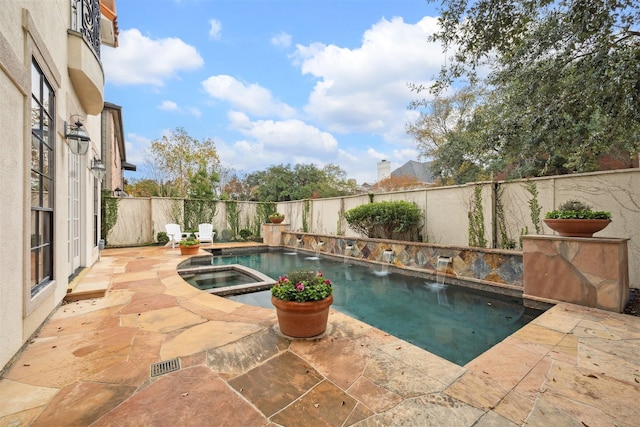 view of swimming pool featuring a patio area and an in ground hot tub