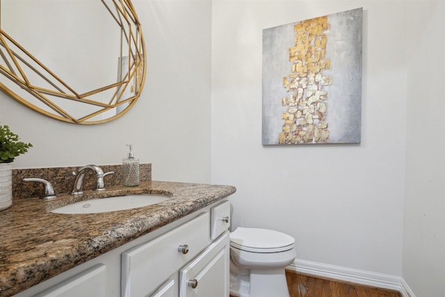 bathroom featuring hardwood / wood-style flooring, vanity, and toilet