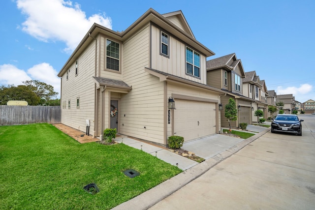 view of property featuring a garage and a front lawn