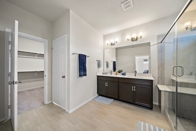 bathroom featuring vanity and an enclosed shower