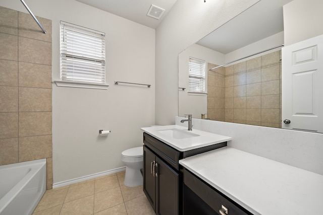 full bathroom with tile patterned flooring, vanity, toilet, and tiled shower / bath