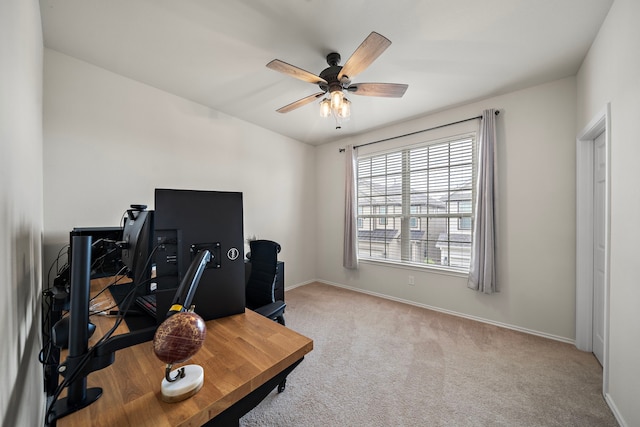 carpeted office space with ceiling fan