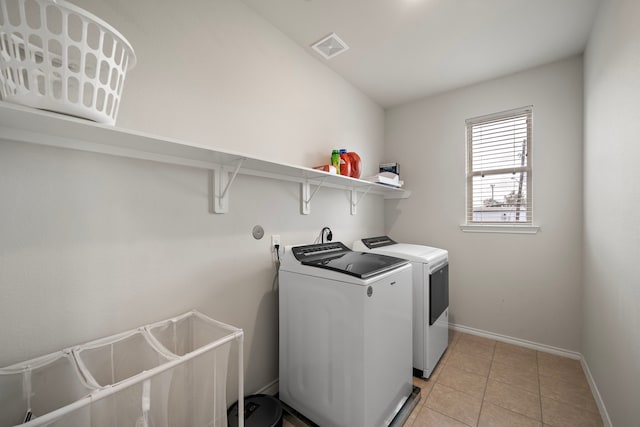 laundry room featuring light tile patterned floors and washer and dryer