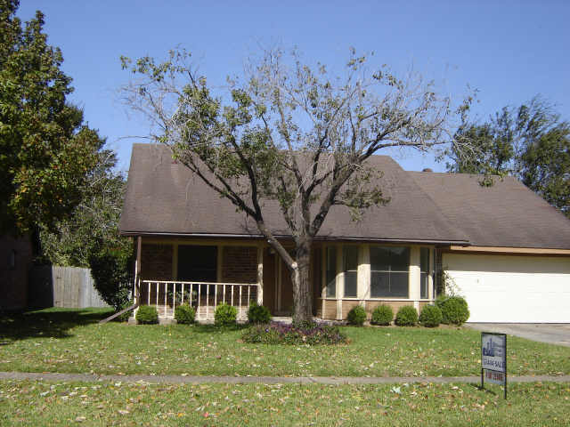 view of front of home with a porch, a garage, and a front yard