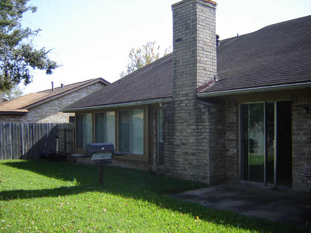 back of house with a yard