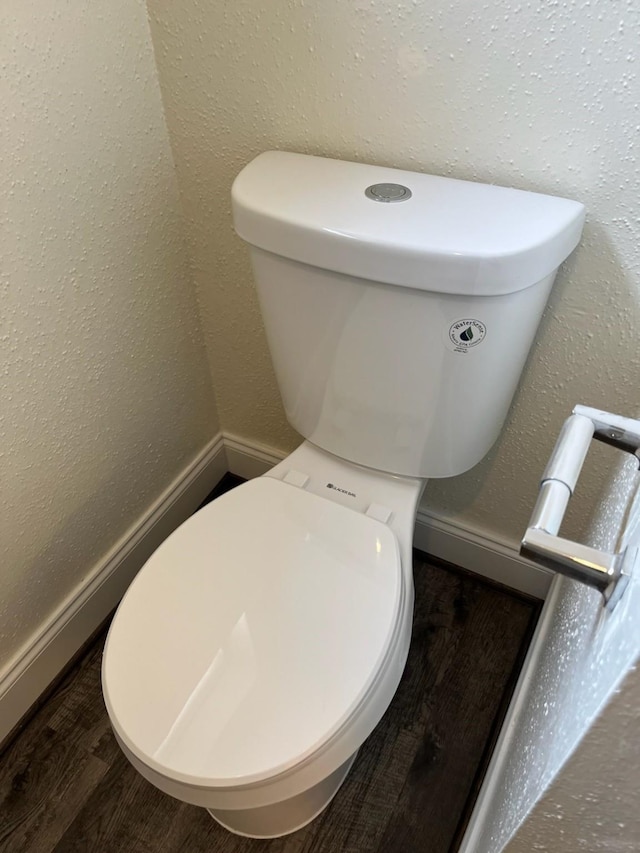 bathroom featuring hardwood / wood-style flooring and toilet