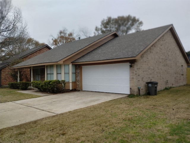 view of side of home featuring a yard and a garage