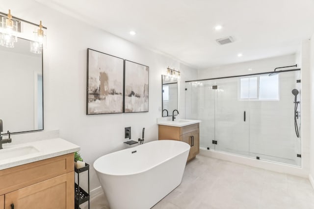 bathroom featuring vanity and independent shower and bath