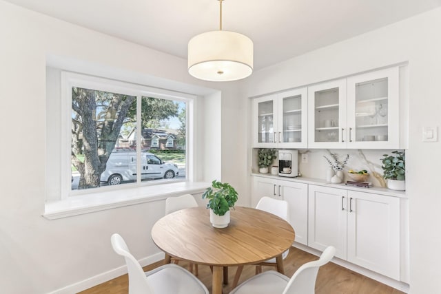 dining space with light hardwood / wood-style floors