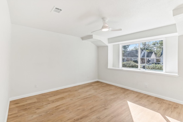 empty room with light hardwood / wood-style flooring and ceiling fan