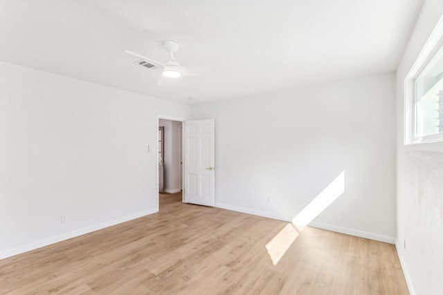 empty room with ceiling fan and light hardwood / wood-style floors