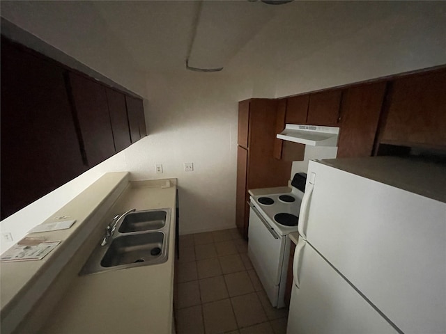 kitchen featuring light tile patterned flooring, white appliances, and sink