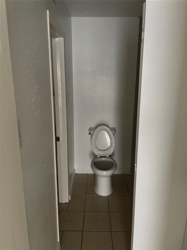 bathroom featuring tile patterned flooring and toilet