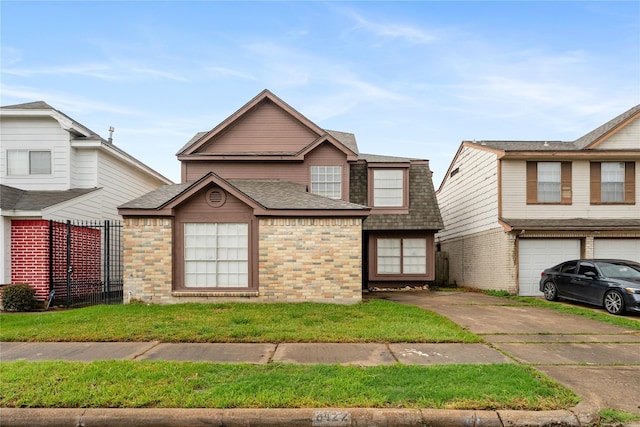 front facade featuring a front yard and a garage