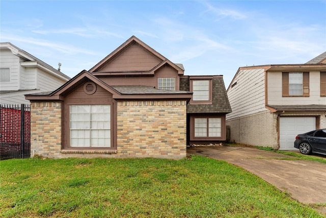 view of front of house with a front yard and a garage