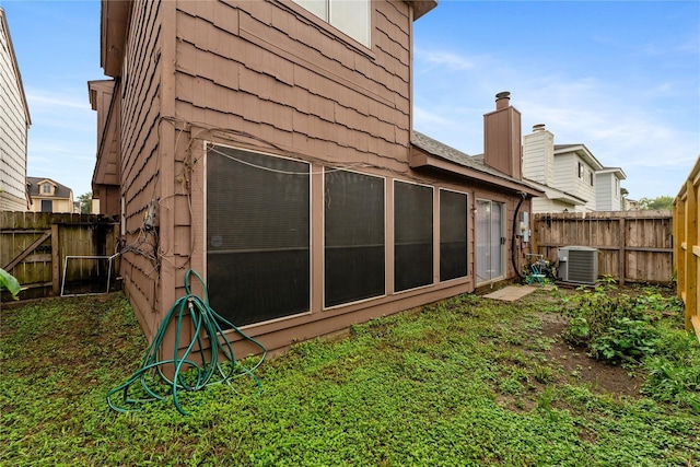 rear view of house featuring central AC unit